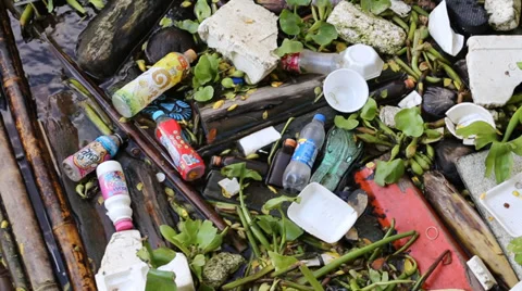 Plastic bottles and containers floating among water in Bangkok, Thailand Stock Footage 38501621
