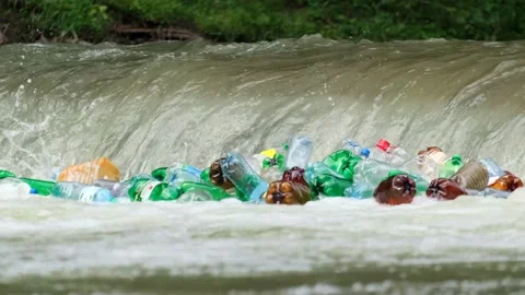 Plastic bottles and garbage in river water Stock Footage