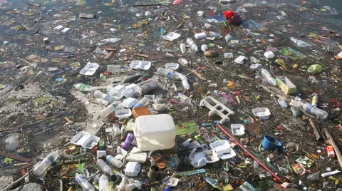 Plastic bottles and other trash floating in ocean Stock Footage 47697014