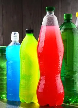 Plastic bottles of assorted carbonated soft drinks in variety of colors Stock Photos