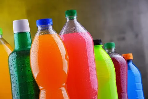 Plastic bottles of assorted carbonated soft drinks in variety of colors Stock Photos