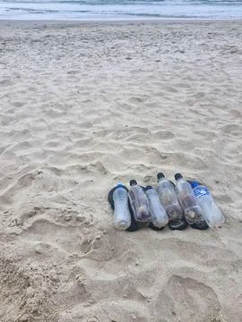 Plastic bottles on the beach sand Stock Photos