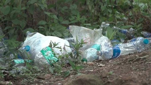 Plastic bottles bundled up in heeps on ground land pollution water marine Video stock 109609585