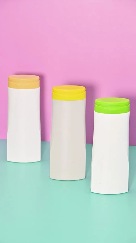 Plastic bottles Changing Places on Pink and blue Background.  Stop Motion Stock Footage 277984483
