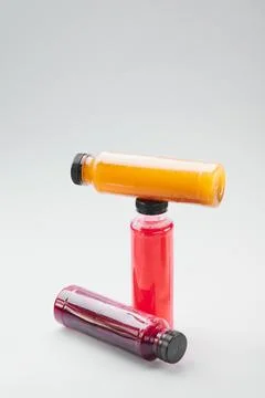 Plastic bottles of cold-pressed unprocessed fruit and vegetable juices, light Stock Photos