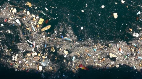 Plastic bottles, discarded food and other debris floating in ocean Stock Footage