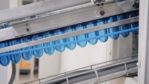 Plastic bottles for drinking water transported by machine Stock Footage 160713554