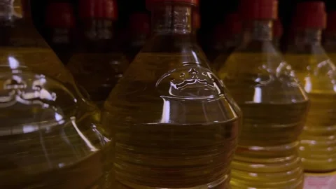 Plastic bottles filled with cooking oil arranged in rows on shelf Stock Footage 334336665