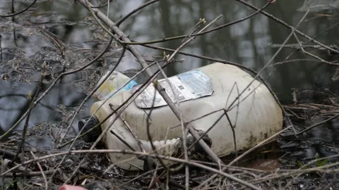 Plastic bottles float in the water. Stock Footage 153375869