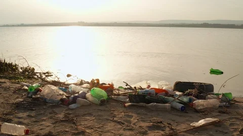 Plastic bottles, garbage on the sandy beach of Black Sea at sunset of the day Stock Footage 108484265