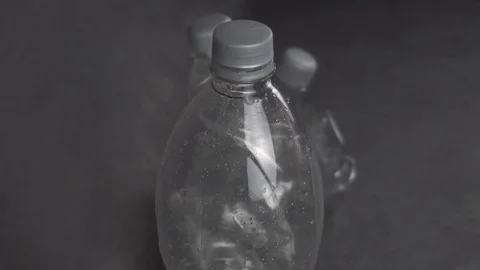 Plastic bottles on gray background Stock Footage 116571301