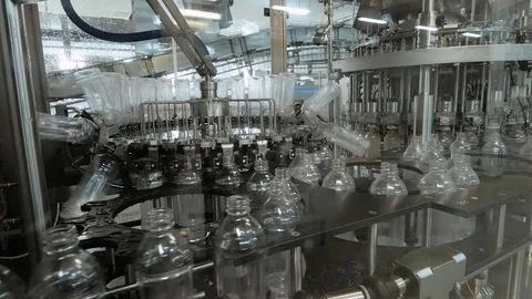 Plastic bottles inside industrial machine conveyor line or belt preparing for Stock Footage 109023123