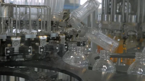 Plastic bottles inside industrial machine conveyor line or belt preparing for Stock Footage 109225196