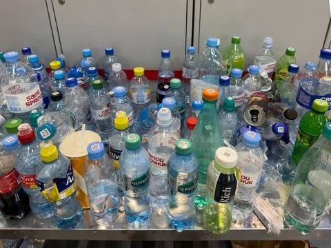Plastic bottles left at airport security checkpoint before passenger screening Foto stock