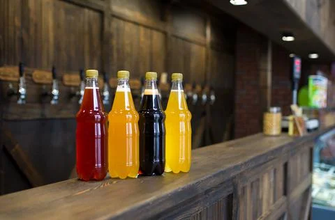 Plastic bottles of light and dark beer on a pub counter. Beer background. Stock Photos