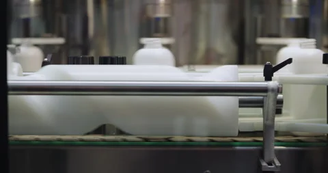 Plastic bottles move through automated production line in modern manufacturing Stock Footage 346226353
