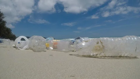 Plastic bottles pollute beach Stock Footage 124447259