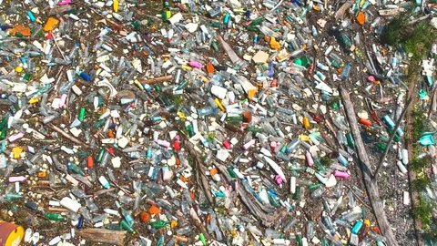 Plastic bottles in a polluted river water Stock Footage 91942939