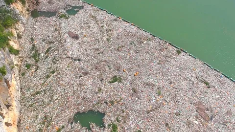 Plastic bottles in a polluted river water Stock Footage 91944097