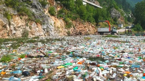 Plastic bottles in a polluted river water Stock Footage 91944320