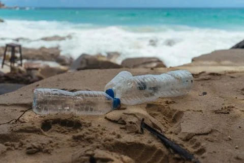 Plastic bottles pollution on the beach left by tourists. Pollution in ocean Stock Photos