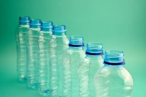 Plastic bottles in a row on a green background 写真素材