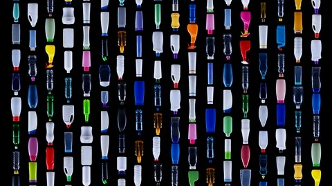 Plastic bottles sliding downward in rows, covering the screen, background Stock-Footage 96703597