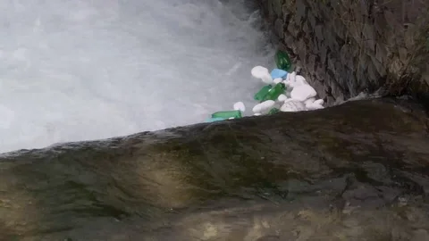 Plastic bottles, styrofoam pieces and other trash floating among the Stock Footage 106482522
