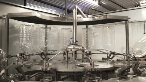 Plastic bottles travel through an automated bottling line for drinking water Stock Footage 161903054