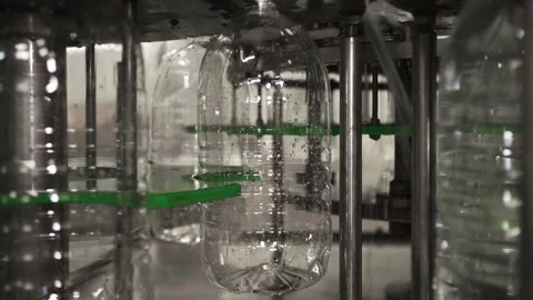 Plastic bottles travel through an automated bottling line for drinking water Stock Footage 161903244