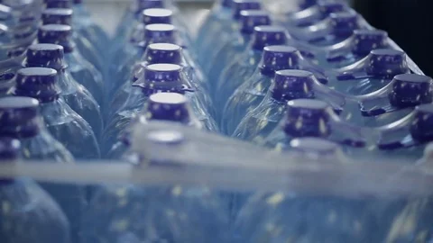Plastic bottles with water in package, rotate in workshop of modern factory. Stock Footage 80610415