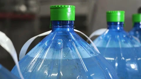 Plastic bottles with water, ride one after another in a row on a conveyor belt Stock Footage 161822546