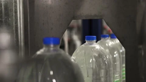 Plastic bottles with water, ride one after another in a row on a conveyor belt Stock Footage 161829957