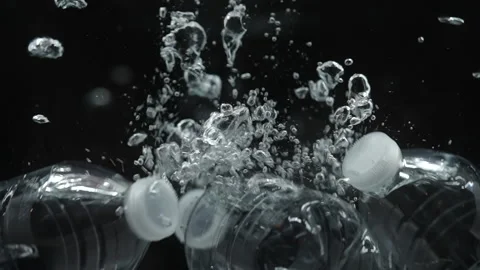Plastic Bottles of Water Splash Isolated on Black Background Stock Footage 170796297