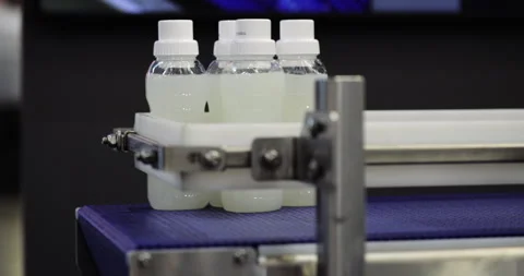 Plastic bottles of white translucent drink transported by conveyor belt Stock Footage 341864002
