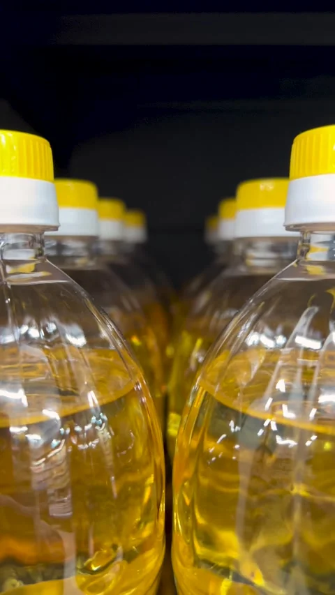 Plastic bottles of yellow vegetable sunflower oil, soybean oil on store shelf Stock Footage 297205208