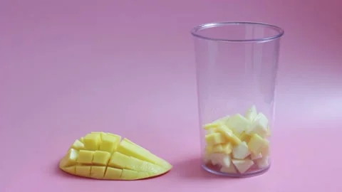 Plastic bowl with fruit for making smoothies on pink background. Stock Footage 155369928