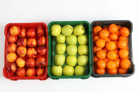 Plastic box with apples on a white background Stock Photos