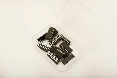 A plastic box with microchips on a white background. A container with elect.. Stock Photos