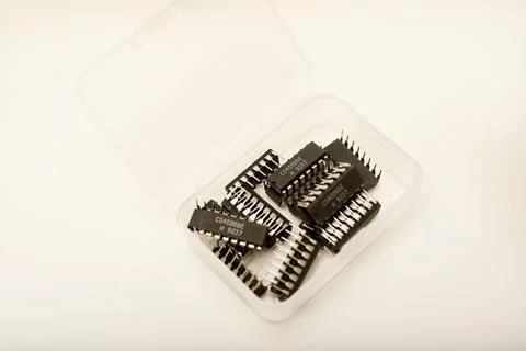 A plastic box with microchips on a white background. A container with elect.. Stock Photos