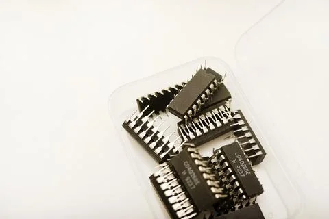 A plastic box with microchips on a white background. A container with elect.. Stock Photos