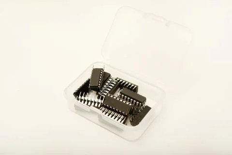 A plastic box with microchips on a white background. A container with elect.. Stock Photos