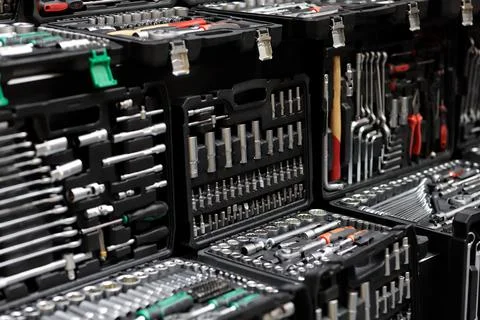 Plastic boxes with mechanic tool sets on showcase Stock Photos