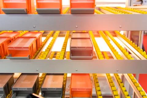 Plastic boxes on the roller conveyor. Modern warehouse equipment. Stock Photos