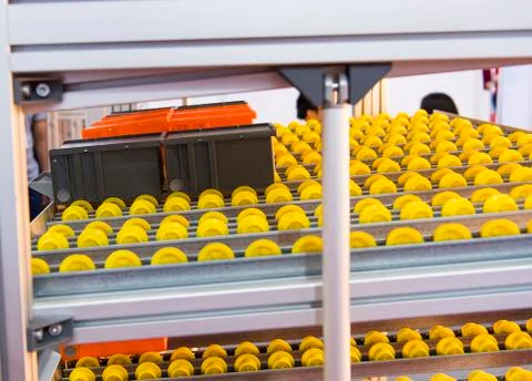Plastic boxes on the roller conveyor. Modern warehouse equipment. Stock Photos