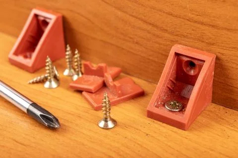 Plastic brackets for connecting chipboard. Small carpentry work in the worksh Stock Photos