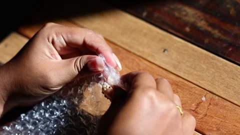 Plastic bubble wrap pressed by hands, sharp popping crackle sounds Stock Footage 329479457