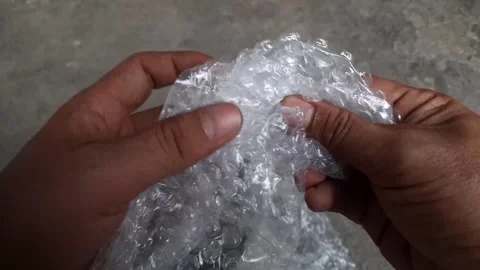 Plastic bubble wrap squeezed by someone Stock Footage 250623908