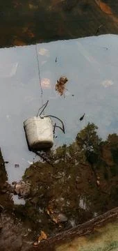 Plastic bucket sinks in river flow Photos