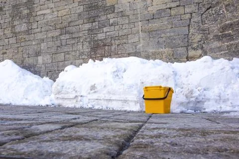 Plastic bucket used as a garbage dump beside the walkway Stock Photos